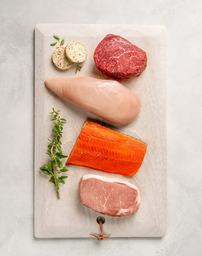 A cutting board with various meats on it